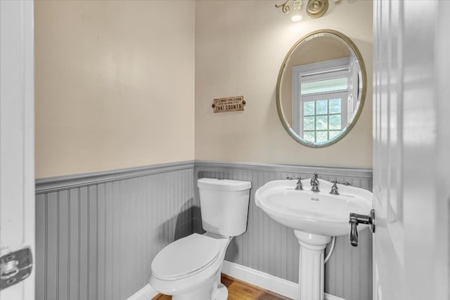 299 Charlotte Dr, Dalton, GA 30720 - half bathroom with wood finished floors and a wainscoted wall
