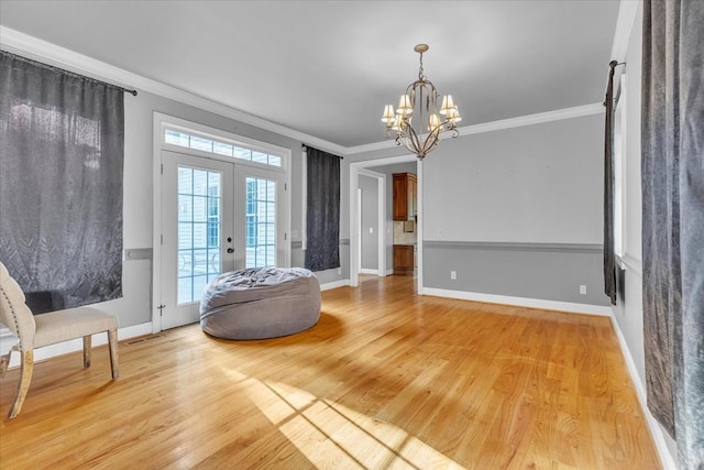 299 Charlotte Dr, Dalton, GA 30720 - entrance foyer featuring crown molding, french doors, a chandelier, and light wood-type flooring