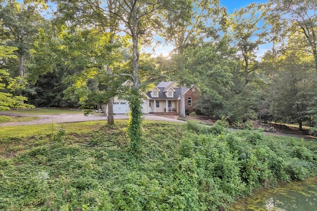 299 Charlotte Dr, Dalton, GA 30720 - view of property hidden behind natural elements featuring concrete driveway and a garage