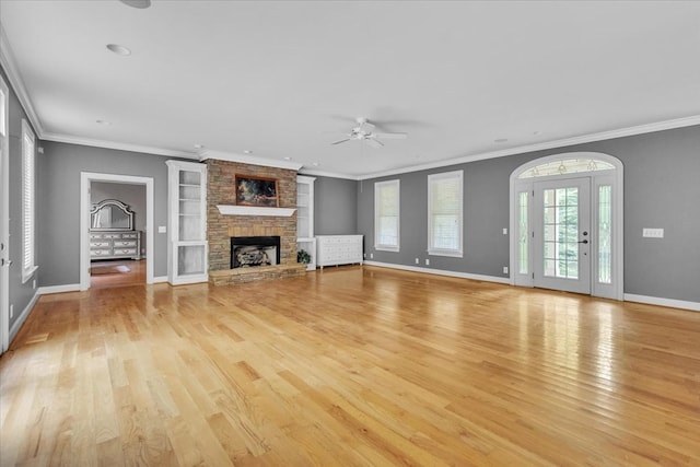 299 Charlotte Dr, Dalton, GA 30720 - unfurnished living room with ceiling fan, a fireplace, light wood-style flooring, built in shelves, and crown molding