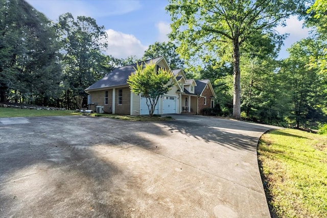 299 Charlotte Dr, Dalton, GA 30720 - cape cod-style house featuring driveway, a garage, and view of scattered trees