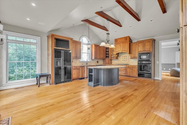 299 Charlotte Dr, Dalton, GA 30720 - kitchen with black appliances, a warming drawer, brown cabinetry, light countertops, and backsplash
