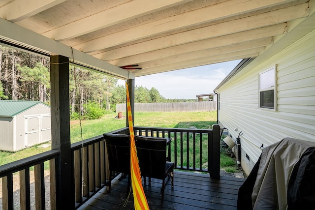 2549 Prospect Rd, Dalton, GA 30721 - wooden deck featuring a lawn, a fenced backyard, a storage unit, and an outdoor structure