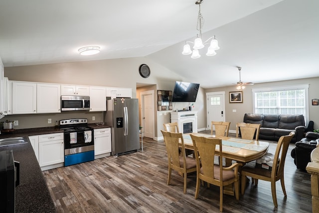 2549 Prospect Rd, Dalton, GA 30721 - dining area featuring dark wood-type flooring, a glass covered fireplace, lofted ceiling, and ceiling fan with notable chandelier