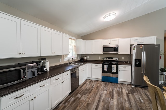2549 Prospect Rd, Dalton, GA 30721 - kitchen with vaulted ceiling, a sink, white cabinets, appliances with stainless steel finishes, and dark wood-type flooring