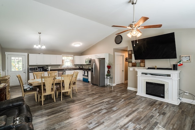 2549 Prospect Rd, Dalton, GA 30721 - dining space with ceiling fan with notable chandelier, a fireplace, high vaulted ceiling, and dark wood finished floors