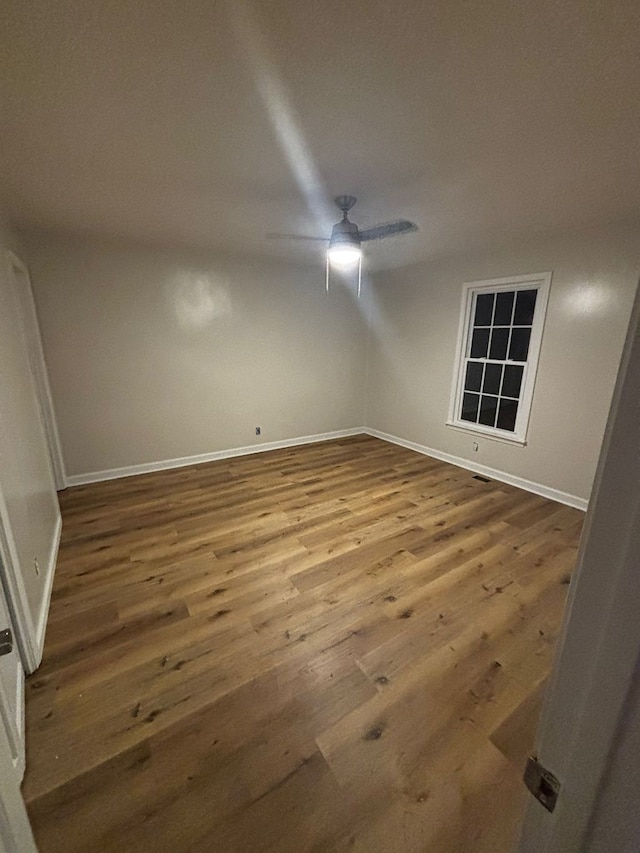 19 5th Ave, Eton, GA 30705 - empty room with wood finished floors, a ceiling fan, and baseboards
