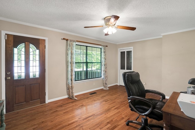 office area with ornamental molding, a healthy amount of sunlight, hardwood / wood-style floors, and a textured ceiling