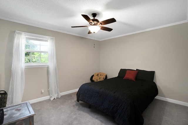 carpeted bedroom with ceiling fan, ornamental molding, and a textured ceiling