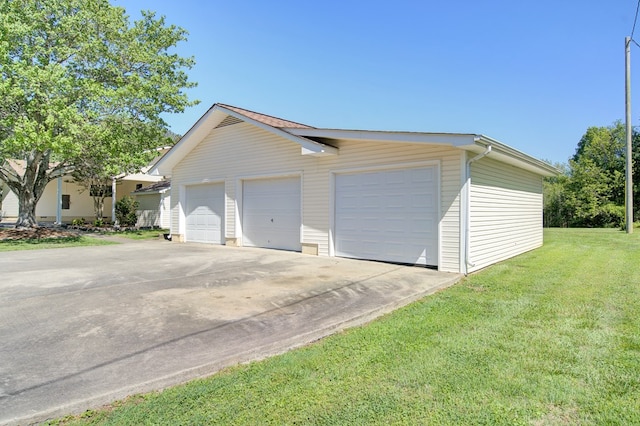 garage featuring a lawn