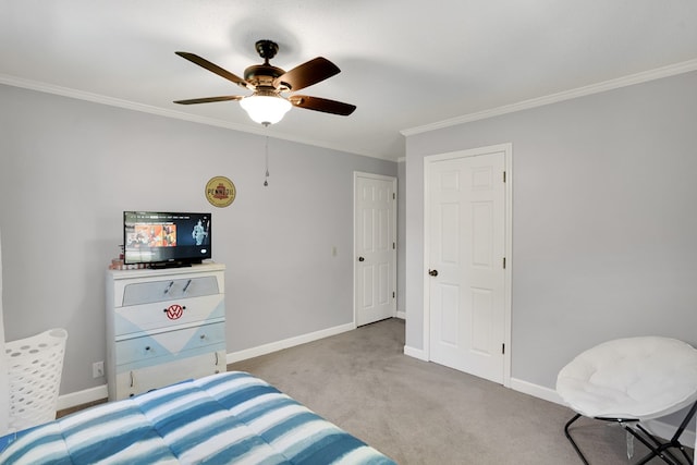 carpeted bedroom with ceiling fan and ornamental molding