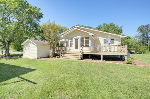 rear view of house featuring a deck and a lawn