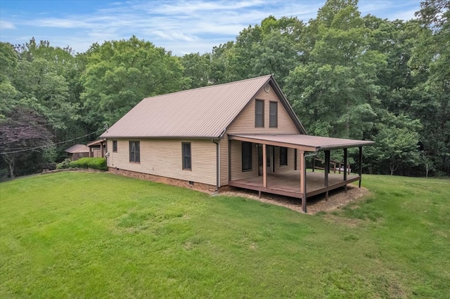 view of side of home featuring a lawn, metal roof, a wooded view, and crawl space