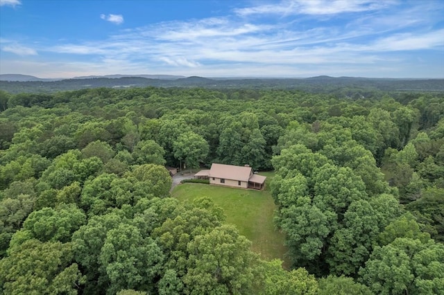 aerial view of property and surrounding area with a forest
