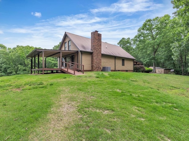 view of property exterior with cooling unit, a yard, metal roof, a chimney, and a wooden deck