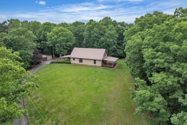 aerial view of property and surrounding area with a forest