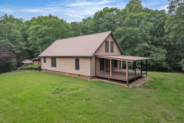 view of side of home featuring a lawn, metal roof, a wooded view, and crawl space