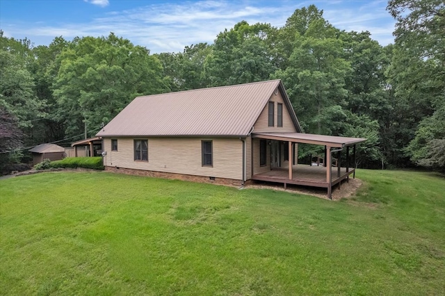 view of home's exterior with a lawn, a deck, metal roof, and crawl space