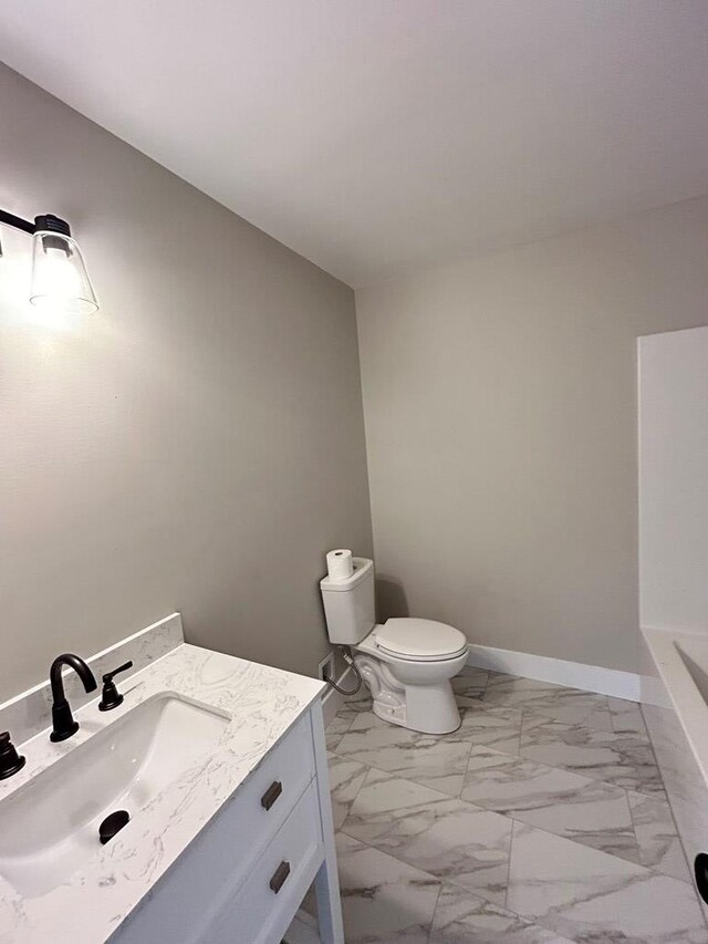 bathroom featuring vanity and toilet