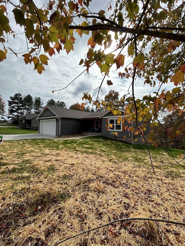 view of front of property with a garage and a front yard