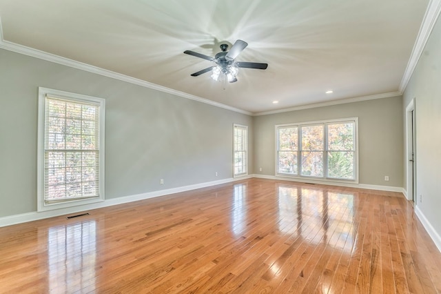 spare room featuring ornamental molding, ceiling fan, and light wood-type flooring