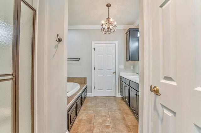 bathroom with crown molding, vanity, a notable chandelier, tile patterned floors, and a tub