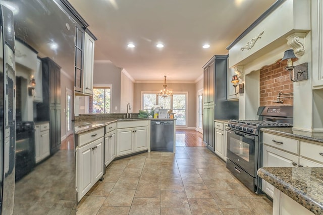 kitchen with decorative light fixtures, sink, dark stone countertops, ornamental molding, and black appliances