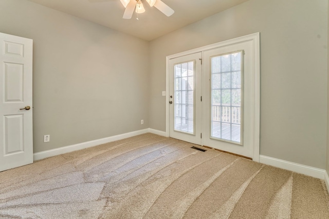 entryway with ceiling fan and carpet flooring