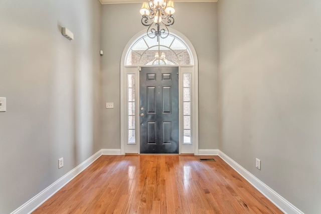 foyer featuring a notable chandelier and light hardwood / wood-style flooring