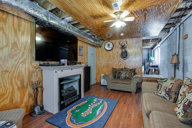 1359 Dustin Dr, Dalton, GA 30720 - living area featuring wooden walls, wood finished floors, ceiling fan, and a fireplace