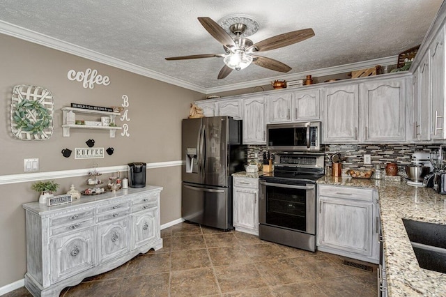 1359 Dustin Dr, Dalton, GA 30720 - kitchen featuring stainless steel appliances, ceiling fan, tasteful backsplash, ornamental molding, and light stone countertops