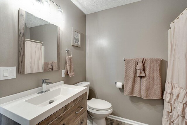 1359 Dustin Dr, Dalton, GA 30720 - bathroom featuring vanity, a textured ceiling, and wood finished floors