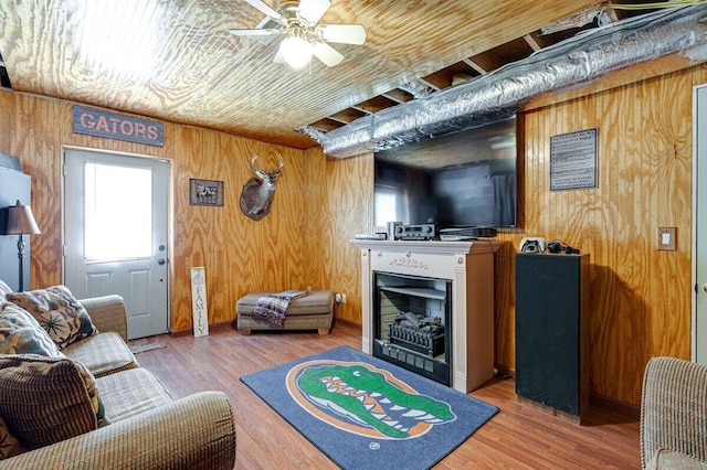 1359 Dustin Dr, Dalton, GA 30720 - living room with wooden walls, a fireplace, a ceiling fan, and light wood-type flooring