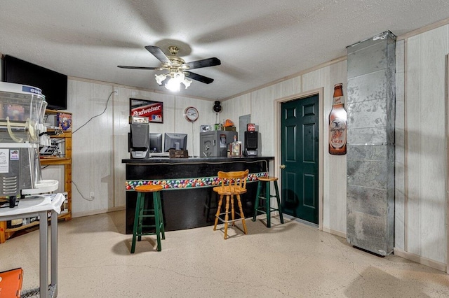 1359 Dustin Dr, Dalton, GA 30720 - bar area with a ceiling fan, speckle patterned floor, refrigerator, wood walls, and a textured ceiling