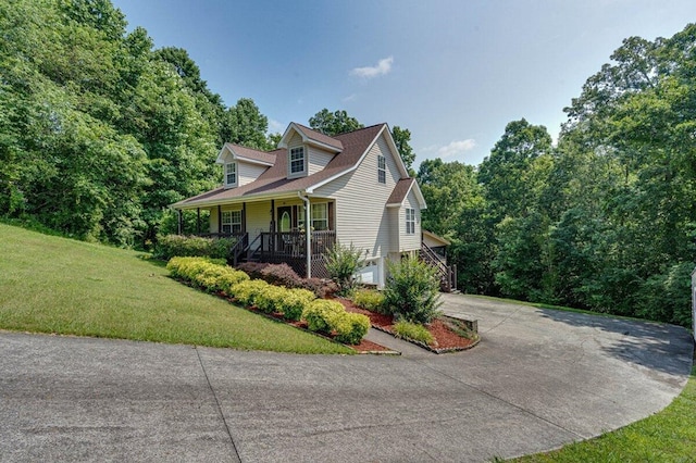 1359 Dustin Dr, Dalton, GA 30720 - view of property exterior featuring driveway, covered porch, a yard, and an attached garage