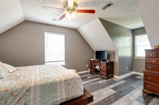 1359 Dustin Dr, Dalton, GA 30720 - bedroom featuring lofted ceiling, a textured ceiling, wood finished floors, and a ceiling fan
