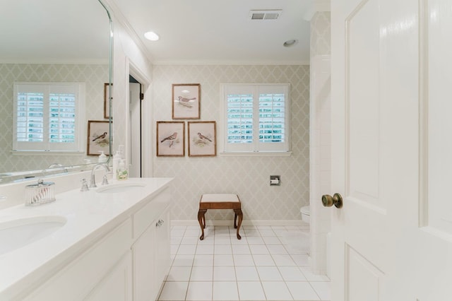 bathroom featuring ornamental molding, vanity, toilet, plenty of natural light, and tile patterned floors