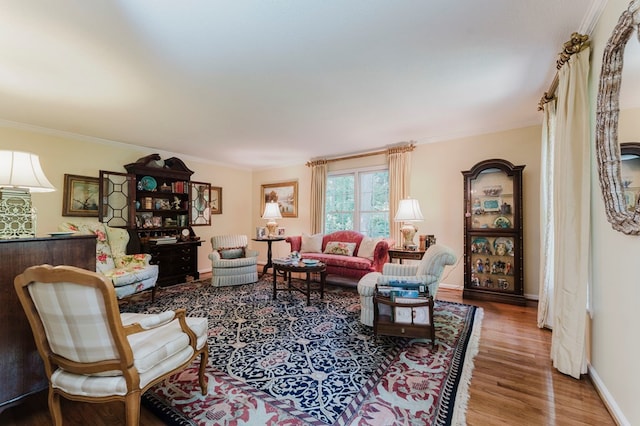 living room featuring hardwood / wood-style flooring and ornamental molding