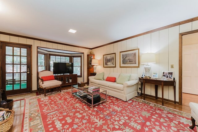 living room featuring hardwood / wood-style flooring and ornamental molding