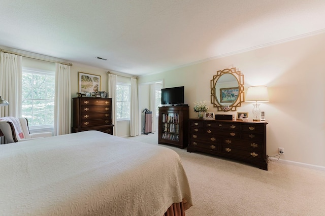 carpeted bedroom featuring crown molding