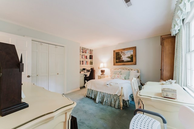 bedroom featuring crown molding, light colored carpet, and a closet