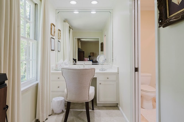 bathroom featuring crown molding, vanity, and toilet