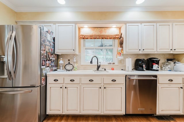 kitchen with stainless steel appliances, crown molding, white cabinets, and light hardwood / wood-style flooring