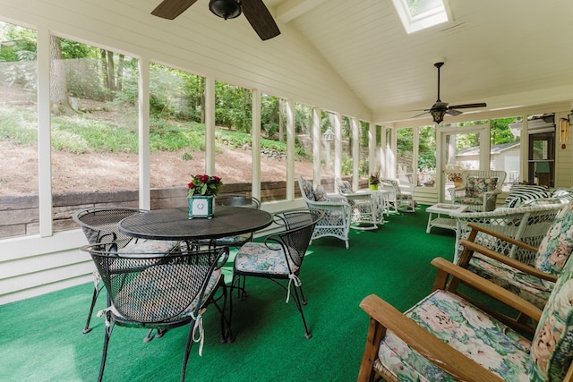 sunroom / solarium with vaulted ceiling with skylight and ceiling fan