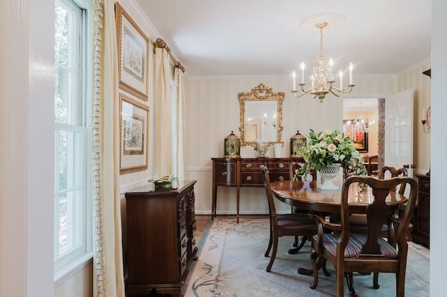 dining space featuring ornamental molding and a chandelier