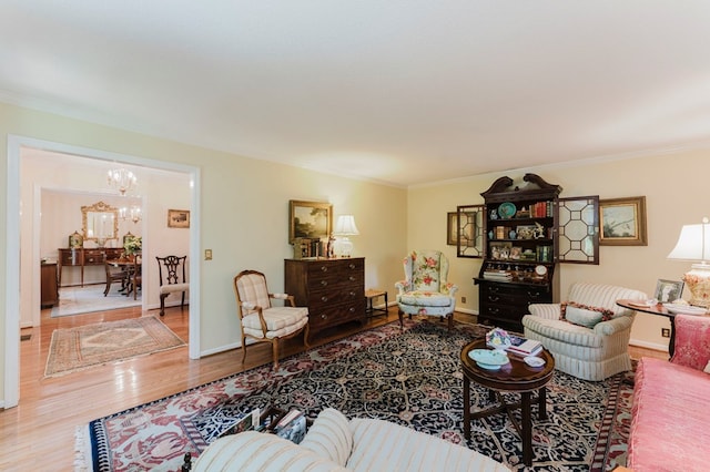 living room with ornamental molding, hardwood / wood-style floors, and a chandelier