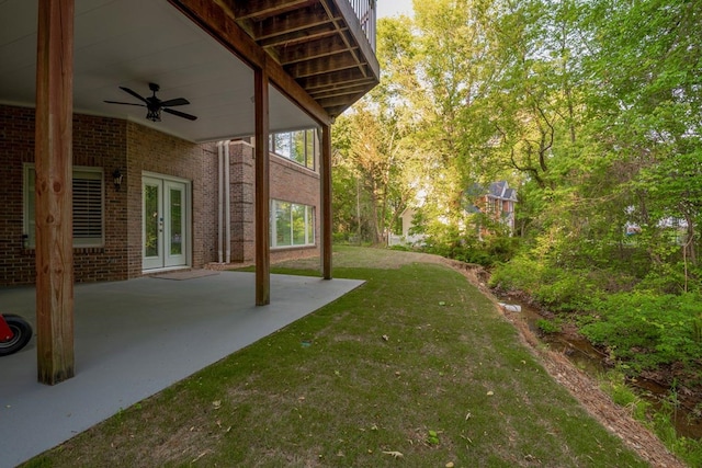 view of yard with a patio area, ceiling fan, and french doors