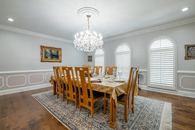 dining room featuring ornamental molding, dark hardwood / wood-style floors, and a chandelier