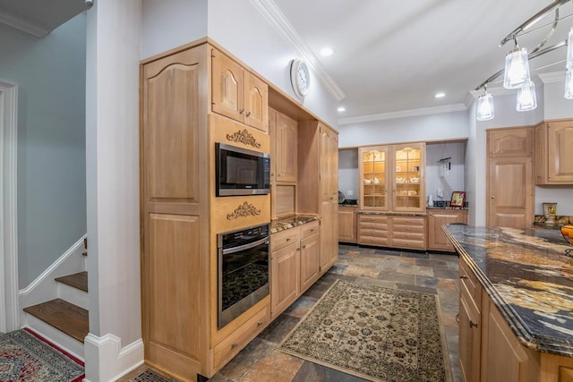 kitchen with dark stone countertops, hanging light fixtures, ornamental molding, built in microwave, and stainless steel oven