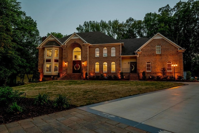 colonial-style house with a yard